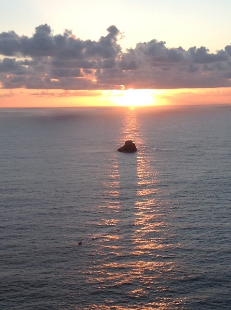 the sun sinking into the ocean at the 'end of the world' - Finisterre